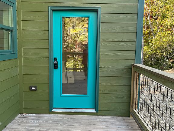 The house is olive and turquoise with vinyl wood floors. Solid stone countertops match in kitchens and baths.