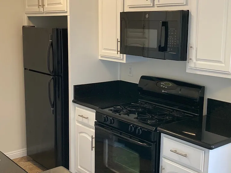 Kitchen with microwave, stove and refrigerator