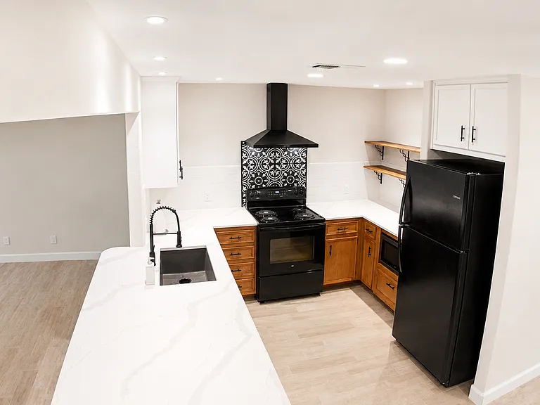 Kitchen with tons of cabinets, 2 large open shelves, deep enough for plates, microwave below counter, fridge, stove, oven and dishwasher included