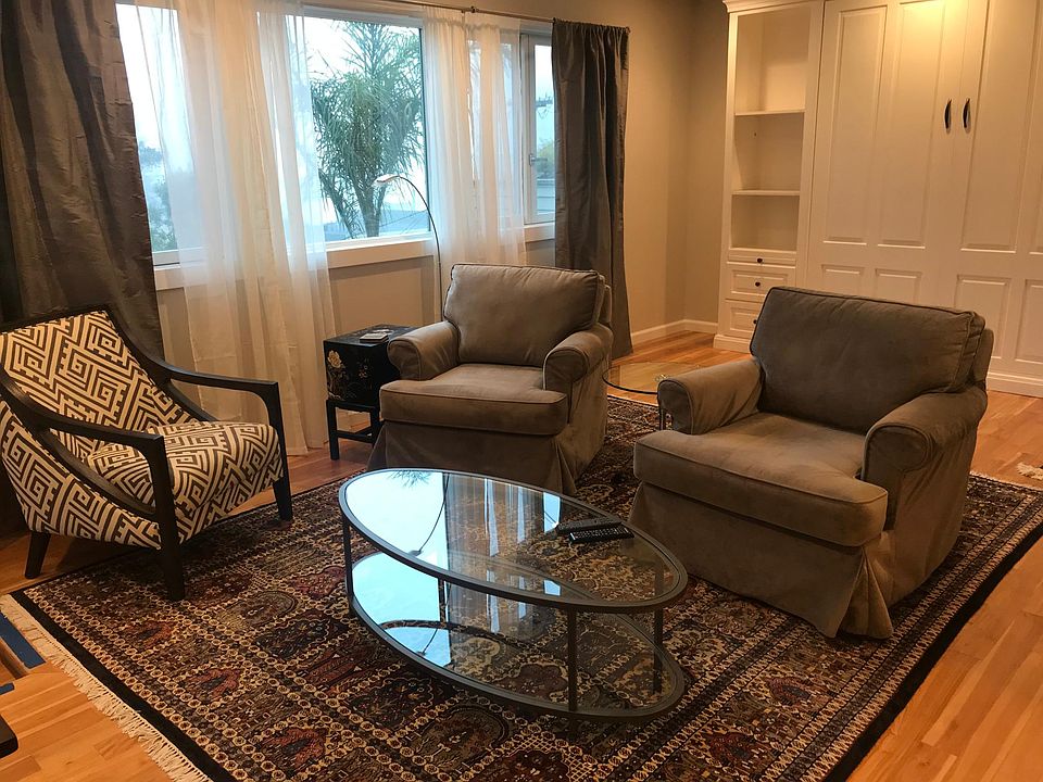 View from doorway into studio. Murphy bed is in white cabinet.