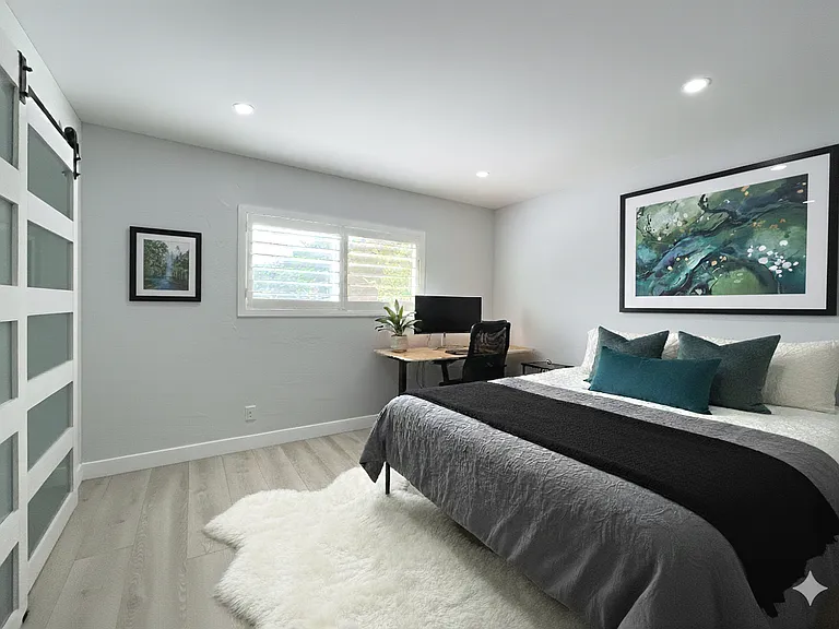 This bedroom room features a built-in desk and bed, offering the perfect setup for a home office, guest space, or hybrid work area.