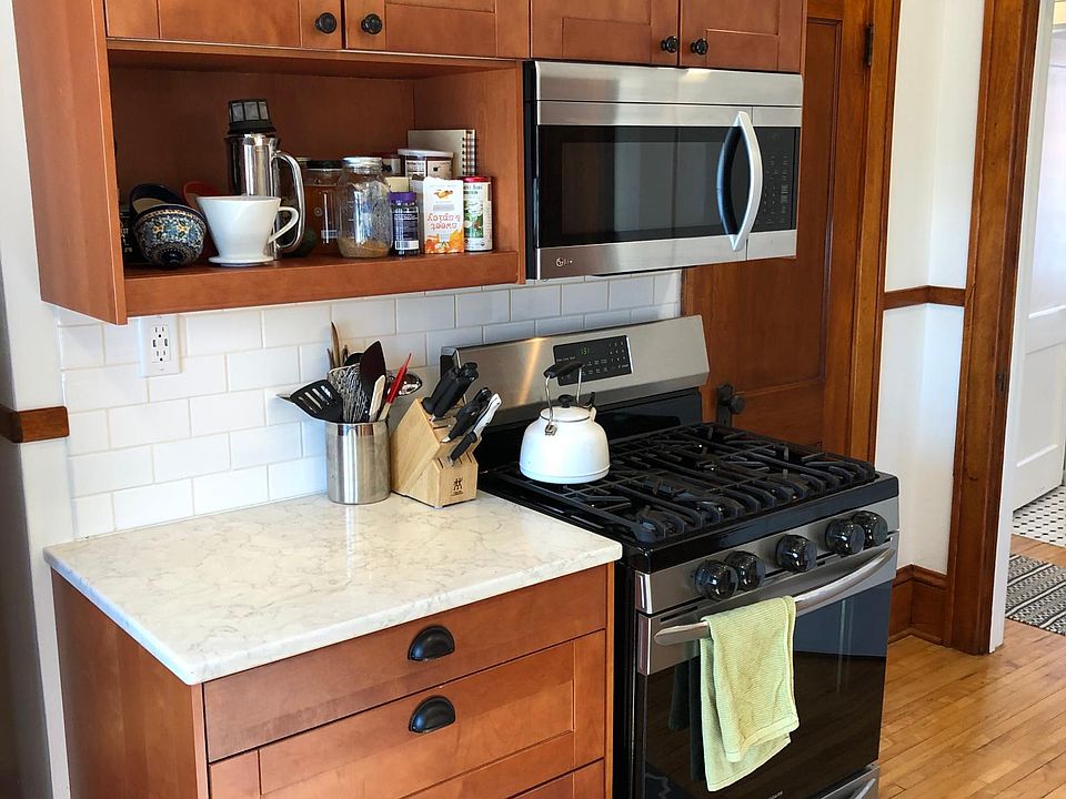 Lots of storage in this clean kitchen. Stainless steel appliances include oven/stove, microwave, dishwasher, microwave.