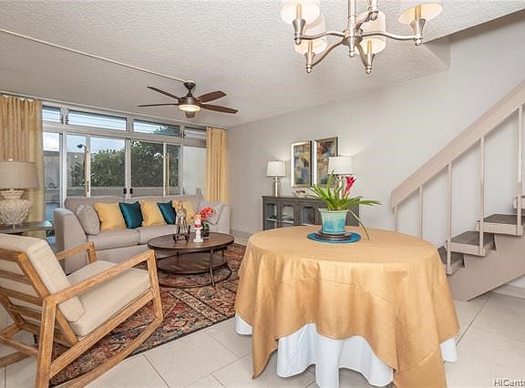 Good natural light enhanced with a new chandelier and ceiling fan makes this living/dining area very appealing.