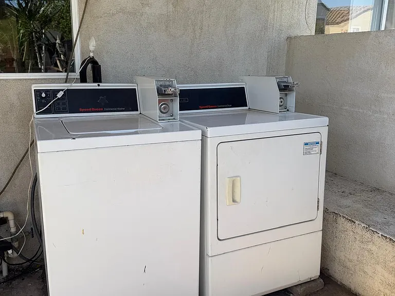 On-site laundry area with a commercial washer and dryer setup for convenient everyday use.