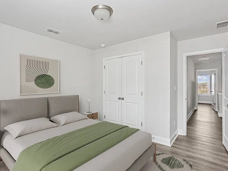 Secondary bedroom with queen size bed and large window letting in a ton of natural light.
