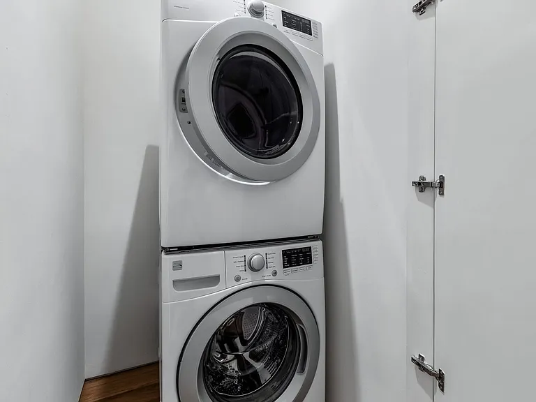 Dedicated laundry area featuring a stacked washer and dryer unit