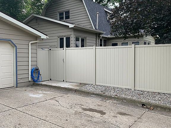 Driveway and vinyl fence add