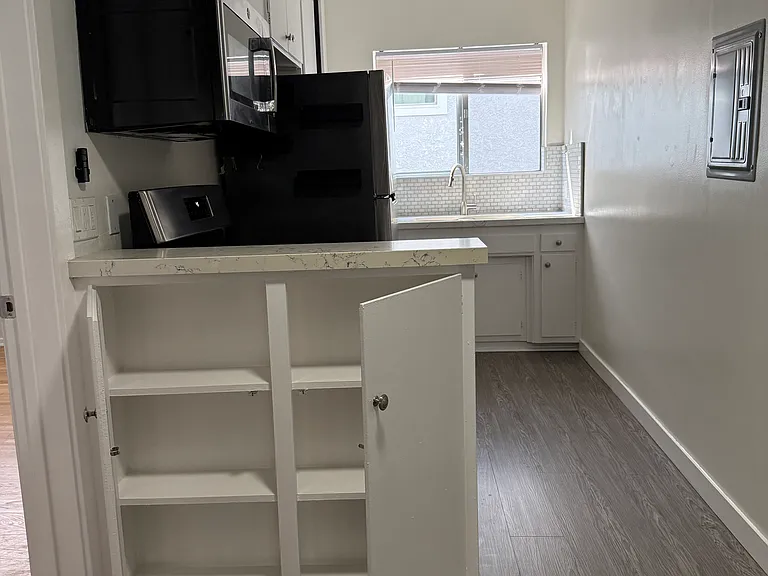 Kitchen and cabinet facing the living room.