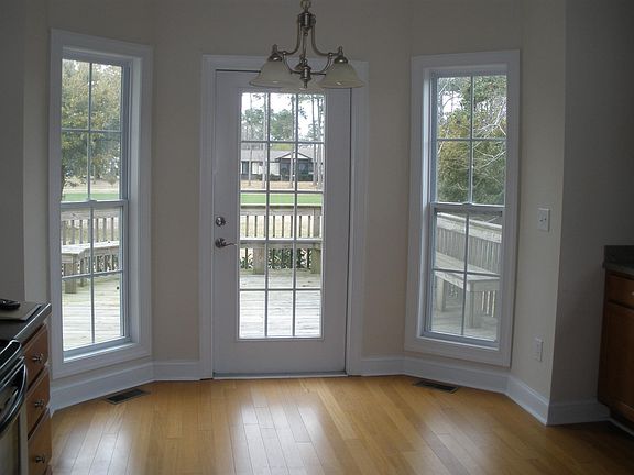 Breakfast nook off kitchen with bay window overlooking deck and 6th hole fairway of Belvedere golf course.