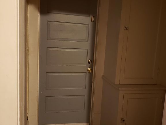 Entry showing storage cabinets