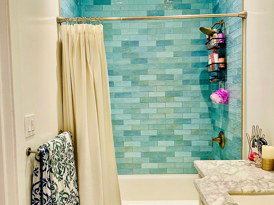 8-foot tall, handmade ceramic tile tub/shower enclosure, marble flooring and new fixtures create a spa experience in this roomy bathroom.
