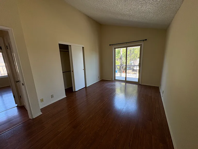 Huge bedroom with cathedral ceiling and slider to private balcony