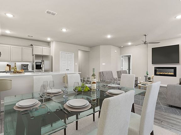 REPRESENTATIVE PHOTO - Open living space in in the Emmy II home plan by Trophy Signature Homes