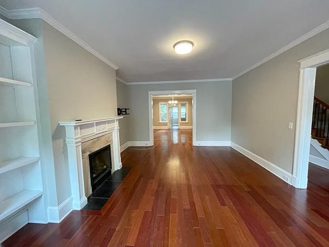 Living Room (20x14)--hardwood floors, crown molding, gas fireplace, built-in bookshelf, 9.5 ft ceilings, overhead light, windows facing Connecticut Avenue