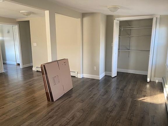 storage/pantry off living area, view of eat in area of kitchen beyond column