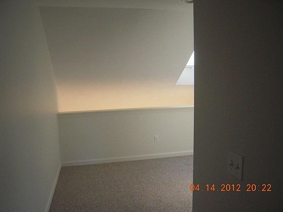 Upstairs hallway with skylight balcony and laundry area