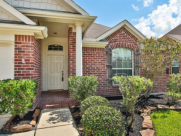 This home welcomes you with a beautiful magnolia tree, nice landscaping, and bricked entry.