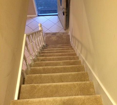 Stairs lead to two bedrooms and full bath with tub