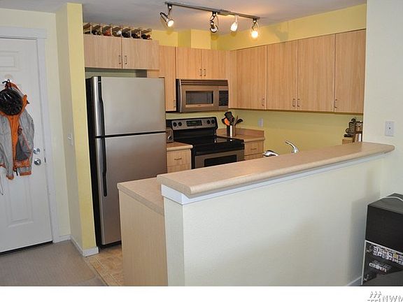 Cozy kitchen is open to dining area and living room.