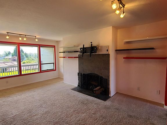 Massive living room. Modern floating shelves. Wood burning fireplace and south facing walls
