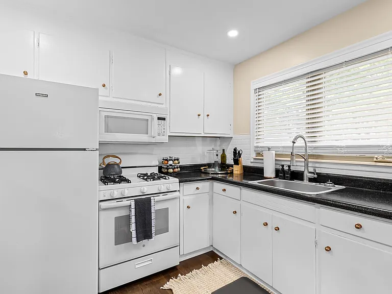 This kitchen is fully equipped for cooking and dining in.