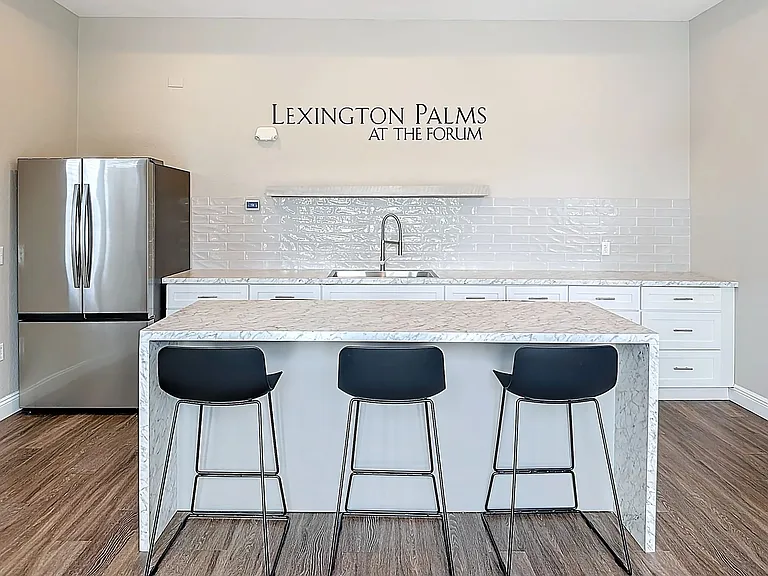 Relax and unwind in the stylish Cabana Room featuring a marble kitchen island, stainless steel appliances, and cozy seating areas.
