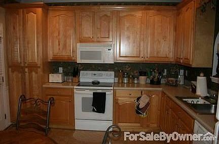 Kitchen
						:
						Large windows and door leading into back yard. View into living room.