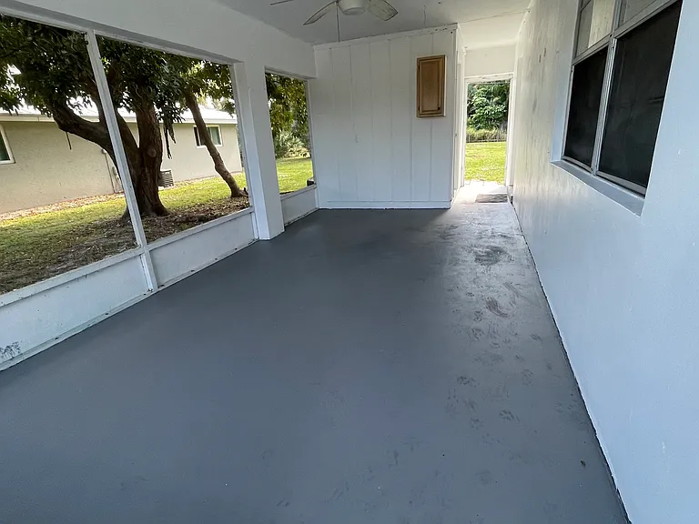 Carport with laundry room and entrance to backyard
