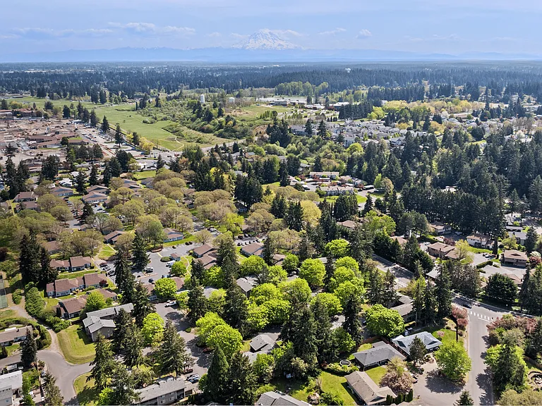 Aerial view of the community and surrounding area with a beautiful view of Mount Rainier in the background.