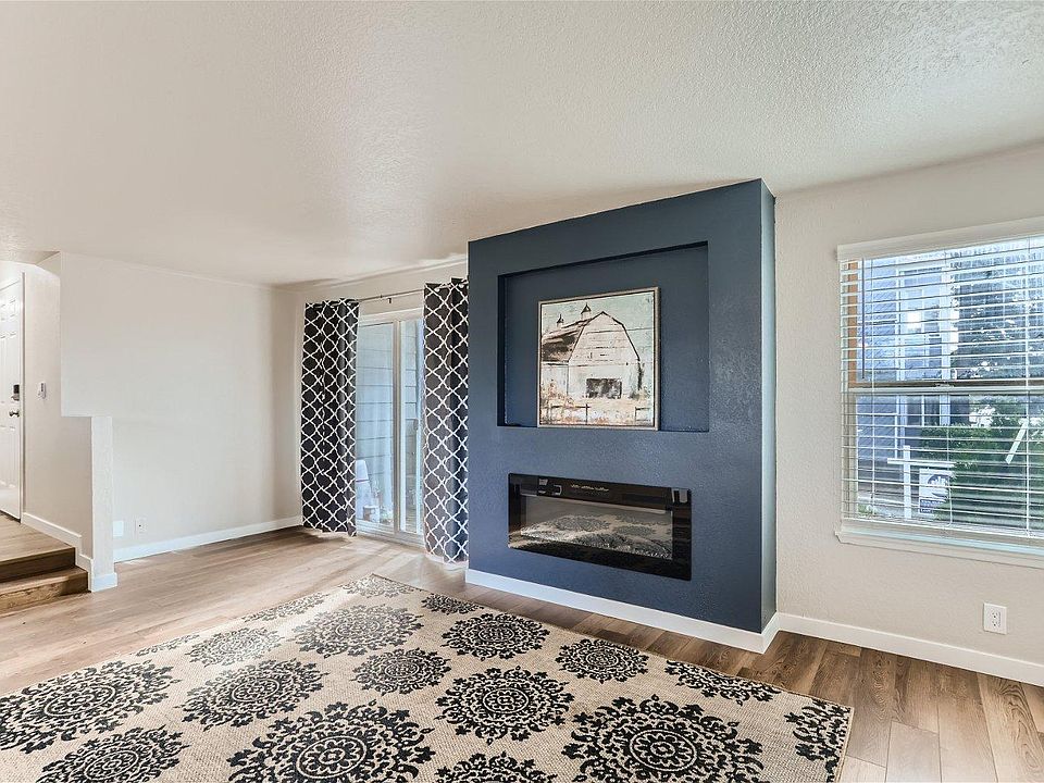 Sunken living room w/ Electronic Fireplace w/ Hardwood Floors & Lots of Oversized Windows