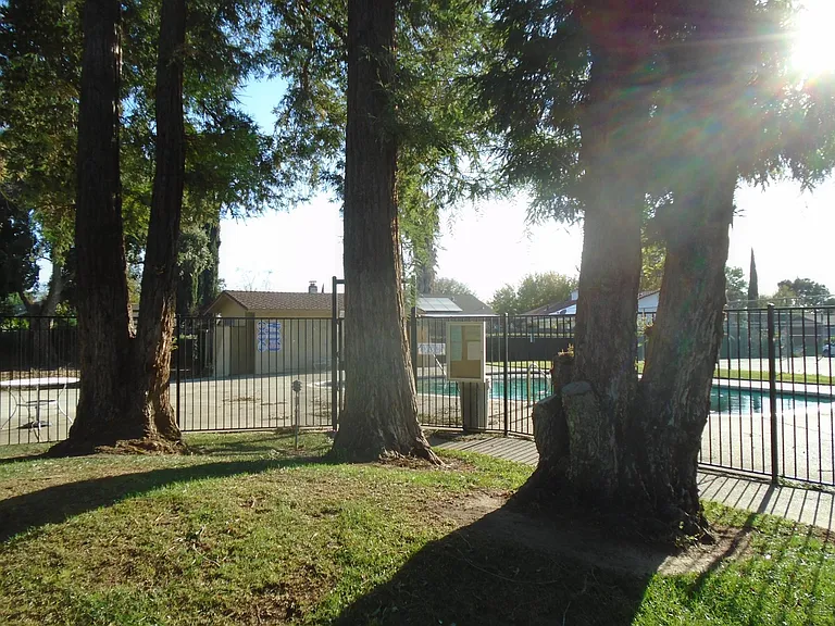 Use the pool and tennis court, and enjoy the beautiful, gated park-like setting right outside your back gate (without the hassle or expense of maintenance.