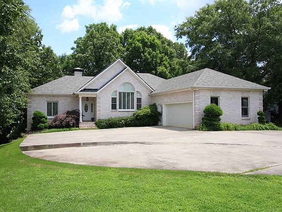 Home features tasteful landscaping, a concrete driveway, and side-entry garage