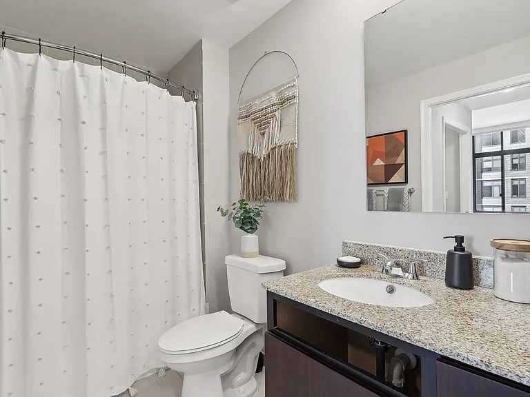 a bathroom with a shower and a sink and a toilet