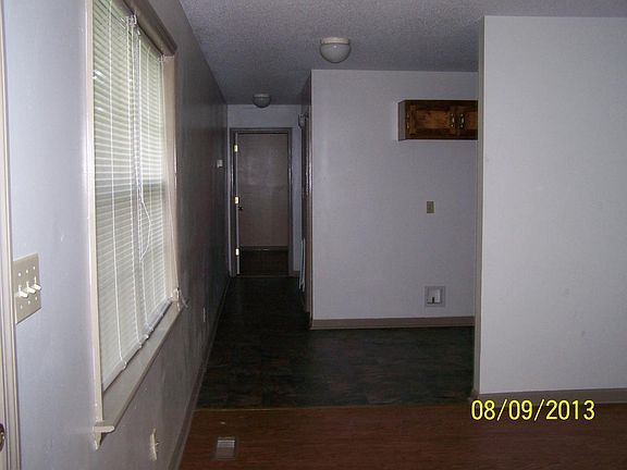 view thru living room, past kitchen, and down hall