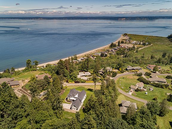 Surrounded by natural beauty with gently sloping trails a sandy beach.