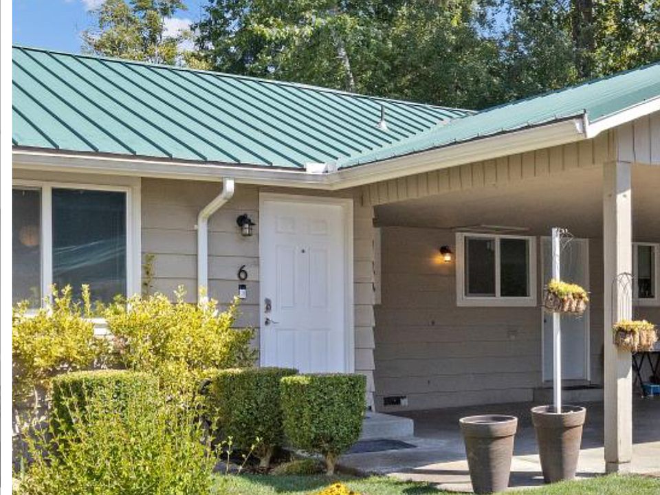 Unit tucked at the end of a quiet cul-de-sac with a well-kept front yard, automatic sprinklers, and a handy hose for easy watering or car washing.