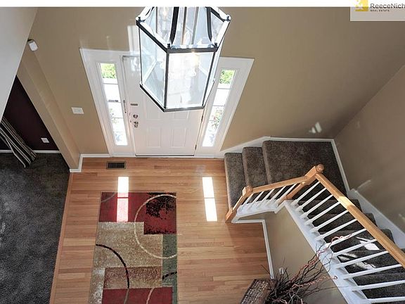 Two Story Entry with wood floor and curved stair case.