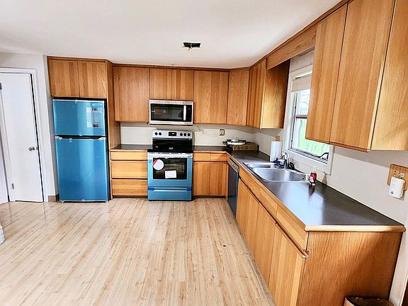 Kitchen with brand new stainless steel appliances, good space for a breakfast nook.
