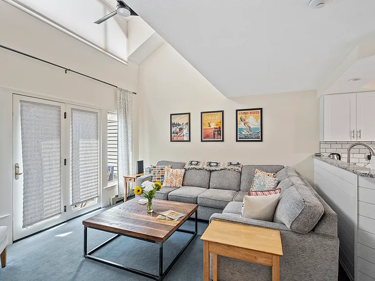 Spacious living room, open concept, high ceilings with a fireplace