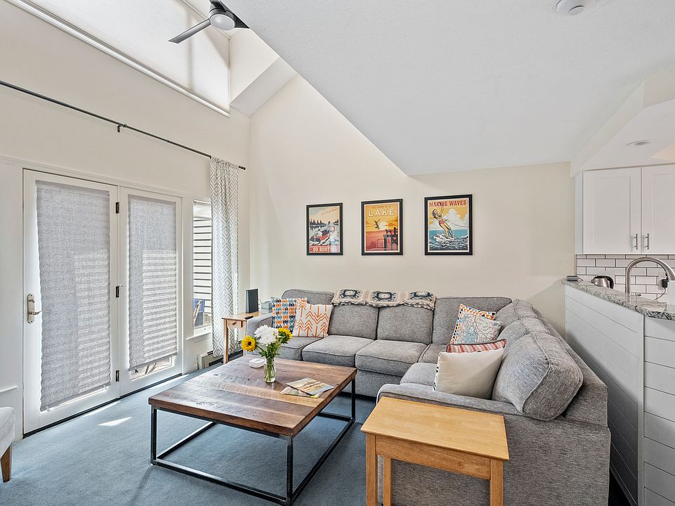 Spacious living room, open concept, high ceilings with a fireplace