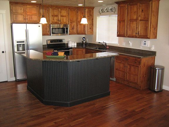 Granite counters, stainless steel appliances & REAL cherry flooing.