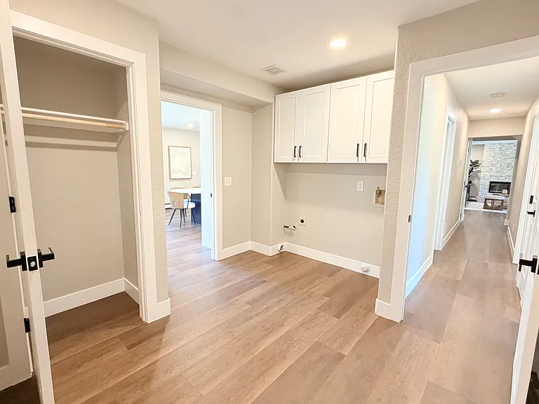 Walking in from the garage, this mudroom + laundry welcomes you and connects to the living spaces and hallway with 2 bedrooms and a bathroom