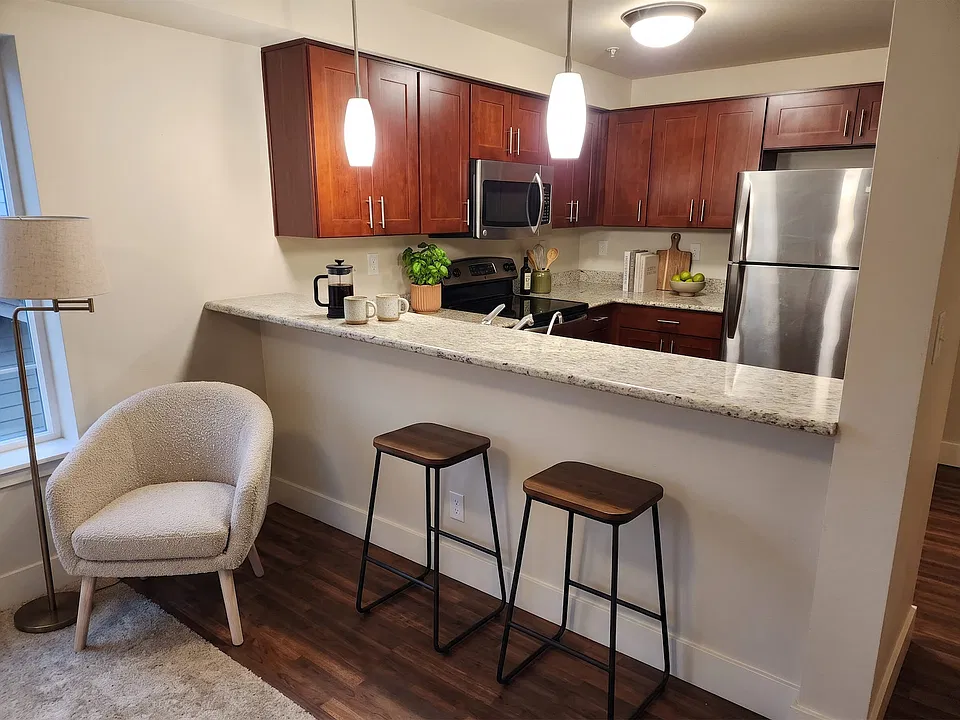 Granite counters and a full stainless appliance package, with bar seating that opens to the living area.