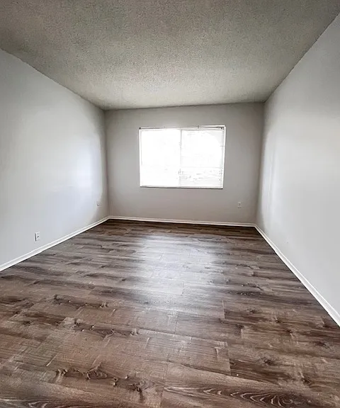 Bedroom with new luxury vinyl plank floor and double closets