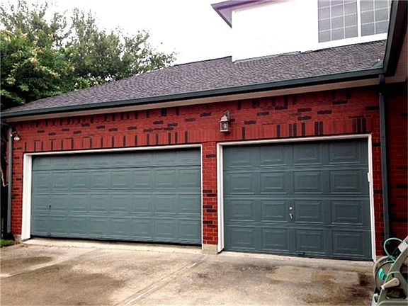 3 Car Garage with lots of shelves.