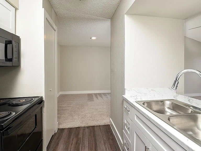 One Bedroom A3 - White Shaker Kitchen Cabinets with Black Appliances