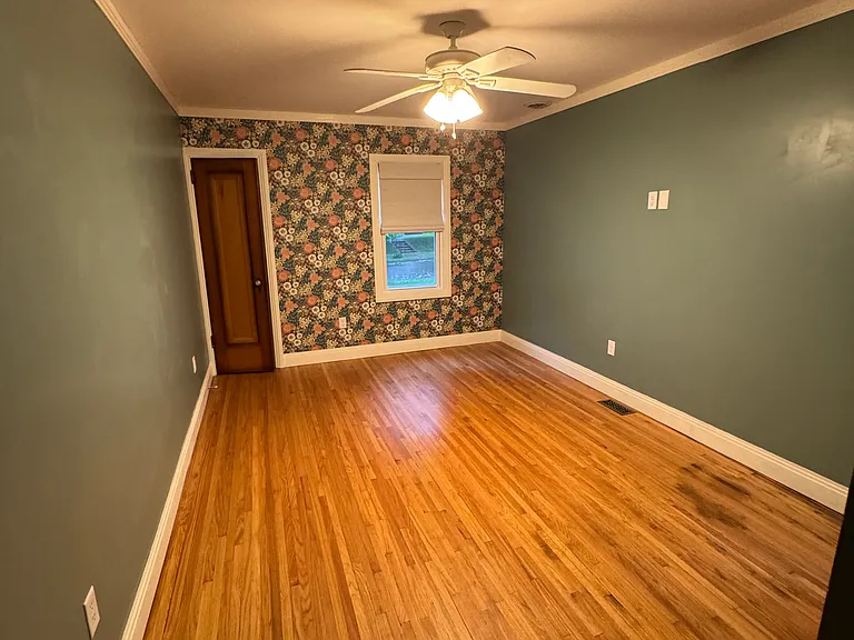 main floor bedroom - view toward front of house with one closet