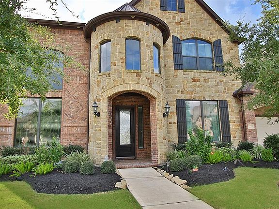 Beautiful brick and stone elevation with lush landscaping that gives great curb appeal!
