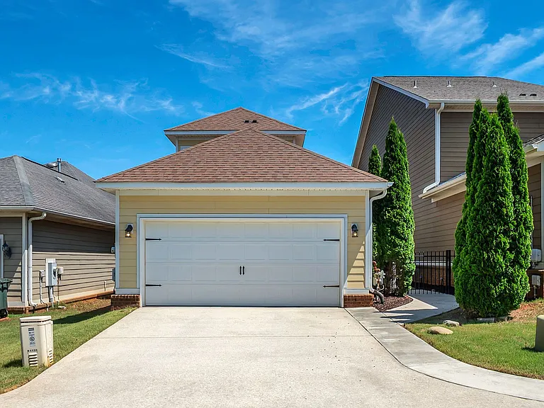 Rear entry garage has alley access and access to the patio