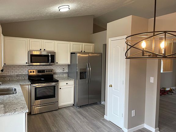 More of this beautiful kitchen which includes a pantry.